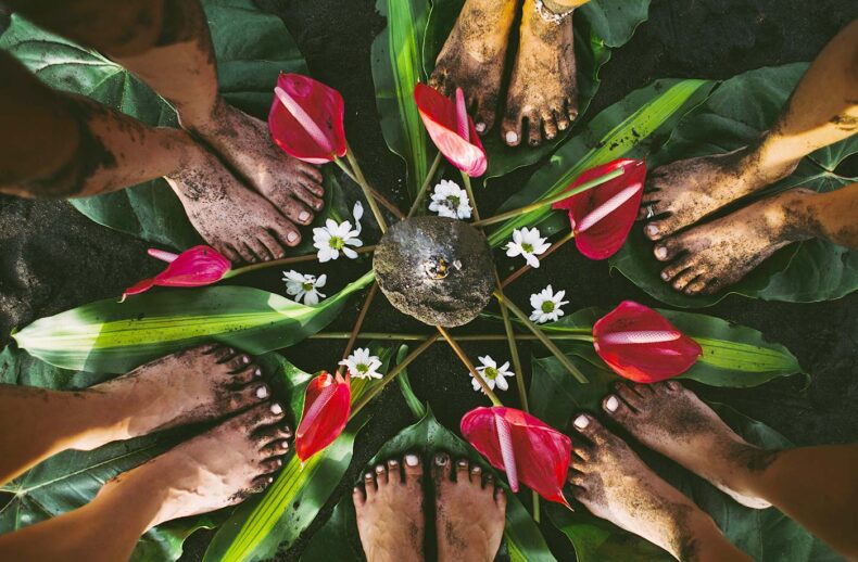 A group of people gathered around the flowers in a harmonious and nature-inspired ceremony