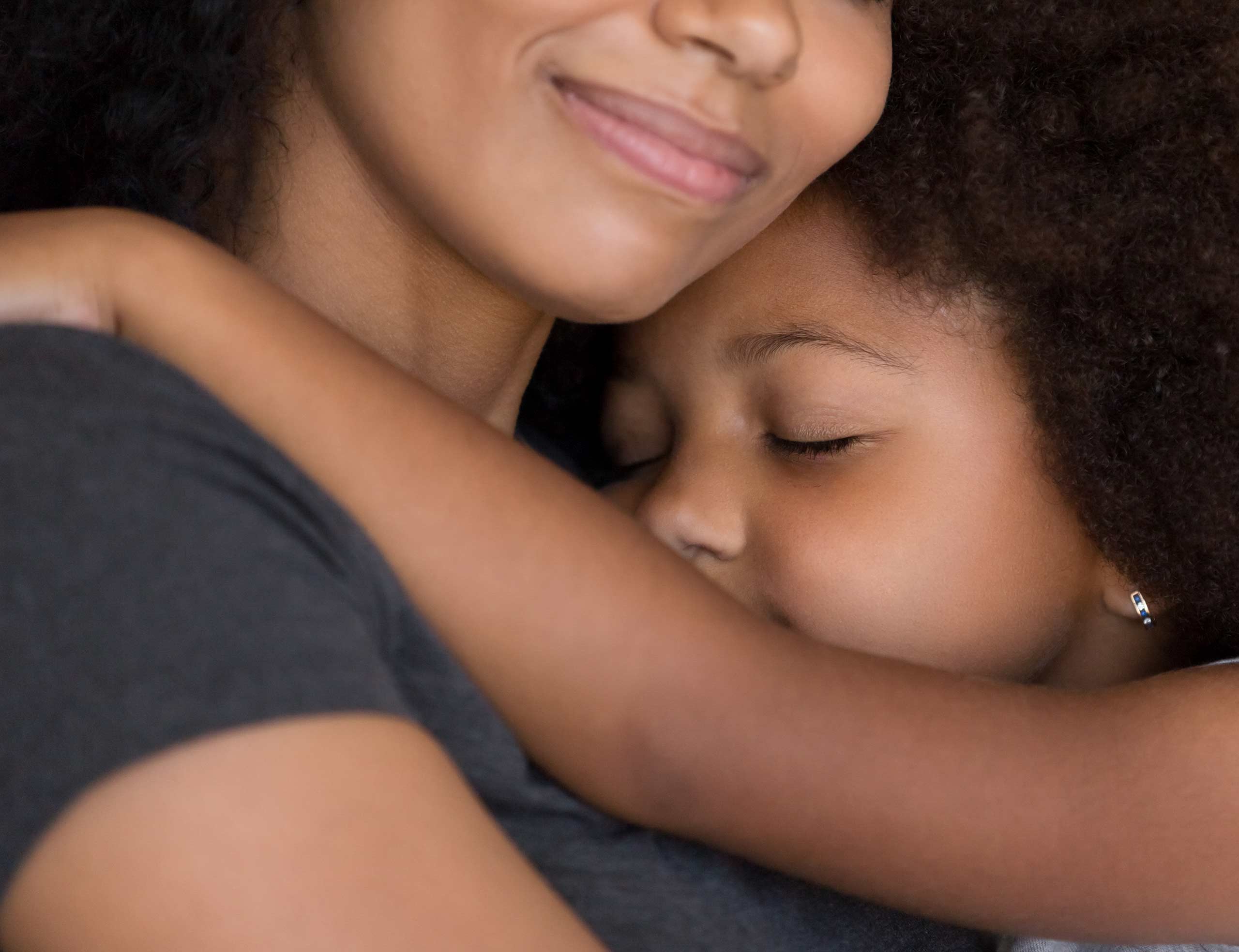 An emotional scene unfolds as a mother and her daughter share a warm and loving hug, expressing their deep bond and connection