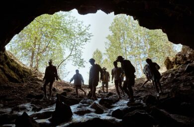 A group of people is entering a cave